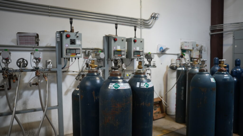 Row of WestAir carbon dioxide cylinders connected to a gas manifold